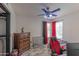 Cozy bedroom features wood floors, modern ceiling fan, and matching red and black accents at 17434 N 46Th Pl, Phoenix, AZ 85032