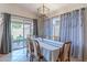 Inviting dining area with sliding glass door to covered patio and modern chandelier lighting at 17434 N 46Th Pl, Phoenix, AZ 85032