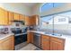 Well-maintained kitchen featuring stainless steel appliances, light countertops, and wood cabinetry at 17434 N 46Th Pl, Phoenix, AZ 85032