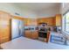 Well-lit kitchen featuring stainless steel appliances, light countertops, and natural wood cabinetry at 17434 N 46Th Pl, Phoenix, AZ 85032