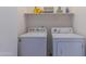 Laundry room featuring a washer and dryer with shelving above them at 17434 N 46Th Pl, Phoenix, AZ 85032