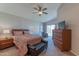 Comfortable main bedroom featuring a ceiling fan, dresser, and access to the outdoor patio at 17434 N 46Th Pl, Phoenix, AZ 85032