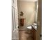 Well-lit bathroom with a granite countertop and decorative southwestern-themed art at 1001 N Pasadena St # 162, Mesa, AZ 85201