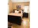 Bedroom features a large window with blinds and a comfortable wood framed bed at 1001 N Pasadena St # 162, Mesa, AZ 85201
