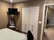Bedroom boasts a double door closet, tv, and neutral color scheme at 1001 N Pasadena St # 162, Mesa, AZ 85201