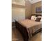 Bedroom features a large window with blinds and a comfortable wood framed bed at 1001 N Pasadena St # 162, Mesa, AZ 85201