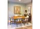 Bright dining room with modern table, chairs, and stylish decor on a decorative carpet at 1001 N Pasadena St # 162, Mesa, AZ 85201