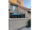 Private enclosed patio with seating area, blue umbrella, and attractive desert accents at 1001 N Pasadena St # 162, Mesa, AZ 85201