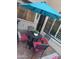 Enclosed patio with tile flooring, umbrella, and comfortable seating at 1001 N Pasadena St # 162, Mesa, AZ 85201