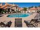 Relaxing community pool with lounge chairs, tanning space, and shallow water marker at 1001 N Pasadena St # 162, Mesa, AZ 85201