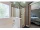 Inviting bathroom featuring a bathtub, shower, and mosaic tile accents, seamlessly connecting to the Primary bedroom at 10228 E Carol Ave, Mesa, AZ 85208