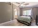Cozy bedroom with a ceiling fan, and large window, showcasing a comfortable retreat at 10228 E Carol Ave, Mesa, AZ 85208