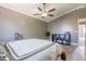 Spacious bedroom with a ceiling fan, hardwood floors, and modern decor offering comfort and style at 10228 E Carol Ave, Mesa, AZ 85208