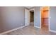 Bright bedroom featuring laminate wood flooring and view into the closet at 10228 E Carol Ave, Mesa, AZ 85208