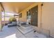 This covered patio features stylish seating with a convenient step down to the backyard at 10228 E Carol Ave, Mesa, AZ 85208
