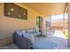 Spacious covered patio with a comfortable lounge area, perfect for outdoor relaxation and entertaining at 10228 E Carol Ave, Mesa, AZ 85208