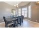 Bright dining room showcasing a wooden table, chandelier, and natural light at 10228 E Carol Ave, Mesa, AZ 85208