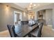 View of open dining area with wooden table with stairs and kitchen access at 10228 E Carol Ave, Mesa, AZ 85208