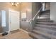 Welcoming home entryway features tile floors, staircase, and natural light at 10228 E Carol Ave, Mesa, AZ 85208