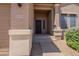 Cozy front entrance with a black screen door, house number, and easy access to the garage at 10228 E Carol Ave, Mesa, AZ 85208