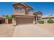 Charming two-story home with an attached two-car garage and low maintenance landscaping at 10228 E Carol Ave, Mesa, AZ 85208
