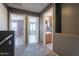 Upstairs hallway with neutral colors and open doorways to bedrooms and bathrooms, promoting seamless transitions at 10228 E Carol Ave, Mesa, AZ 85208