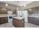 Kitchen featuring an island, modern appliances, and ample counter space at 10228 E Carol Ave, Mesa, AZ 85208