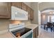 Updated kitchen featuring white appliances, a black stovetop, and dark cabinetry at 10228 E Carol Ave, Mesa, AZ 85208