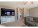 Relaxing living room with a modern entertainment center and open flow to the laundry room at 10228 E Carol Ave, Mesa, AZ 85208