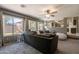 Open concept living area with an oversized sofa and large windows at 10228 E Carol Ave, Mesa, AZ 85208