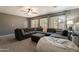 Spacious living room features a ceiling fan and oversized windows providing natural light at 10228 E Carol Ave, Mesa, AZ 85208