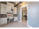 Bright home office featuring built in shelving with view to dining room at 10228 E Carol Ave, Mesa, AZ 85208