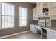 Bright home office with built in shelving, and two windows at 10228 E Carol Ave, Mesa, AZ 85208