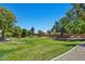 Expansive backyard with lush green lawn, mature trees, and a peaceful ambiance at 10347 W Mohawk Ln, Peoria, AZ 85382
