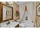 Elegant bathroom with classic wallpaper, framed mirror, shower and a garden flower arrangement at 10347 W Mohawk Ln, Peoria, AZ 85382