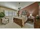 Comfortable bedroom boasts natural light from a large window, a ceiling fan, and stylish decor at 10347 W Mohawk Ln, Peoria, AZ 85382