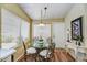 Cozy dining area featuring a glass table with seating for four at 10347 W Mohawk Ln, Peoria, AZ 85382