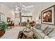 Open living room boasting high ceilings, ceiling fan and direct access to kitchen at 10347 W Mohawk Ln, Peoria, AZ 85382
