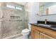 Modern bathroom with glass walk-in shower, decorative tile, and wood vanity at 1042 E Utopia Rd, Phoenix, AZ 85024