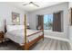 Relaxing bedroom with a four-poster bed, a window view, and neutral decor at 1042 E Utopia Rd, Phoenix, AZ 85024