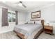 Cozy bedroom featuring a queen-size bed, a ceiling fan, and a bright window at 1042 E Utopia Rd, Phoenix, AZ 85024