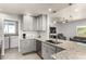 Modern kitchen with granite countertops, stainless steel appliances, and adjacent laundry area at 1042 E Utopia Rd, Phoenix, AZ 85024