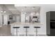 Modern kitchen with granite countertops, seating at the peninsula, and stainless steel appliances at 1042 E Utopia Rd, Phoenix, AZ 85024
