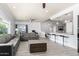 Inviting living area featuring sleek gray sofas, stylish flooring, and seamless access to the kitchen at 1042 E Utopia Rd, Phoenix, AZ 85024