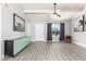 Inviting living room with wood-look floors, ceiling fan, modern decor, and a bright front door at 1042 E Utopia Rd, Phoenix, AZ 85024