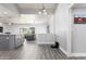 Open concept living space with kitchen island, modern lighting, and easy access to living room at 1042 E Utopia Rd, Phoenix, AZ 85024