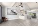 Bright, open living room with modern decor, ceiling fan, and seamless flow to the kitchen at 1042 E Utopia Rd, Phoenix, AZ 85024