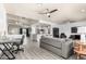 Open-concept living space with a modern gray couch and views into the kitchen at 1042 E Utopia Rd, Phoenix, AZ 85024