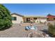Charming backyard featuring a stone fountain, a covered patio, and low-maintenance landscaping at 1051 S 81St Way, Mesa, AZ 85208