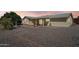 Wide view of the backyard with desert landscaping, a charming fountain, and covered patio area at 1051 S 81St Way, Mesa, AZ 85208